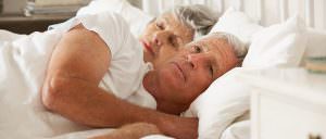 older couple laying in bed